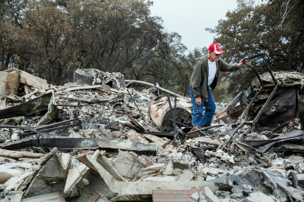 Jay Albertson searches through the rubble of his home of 30 years after it was burned by the Valley fire in Hidden Valley Lake, Calif. "This is a chapter in our lives that is gone forever," said Albertson.