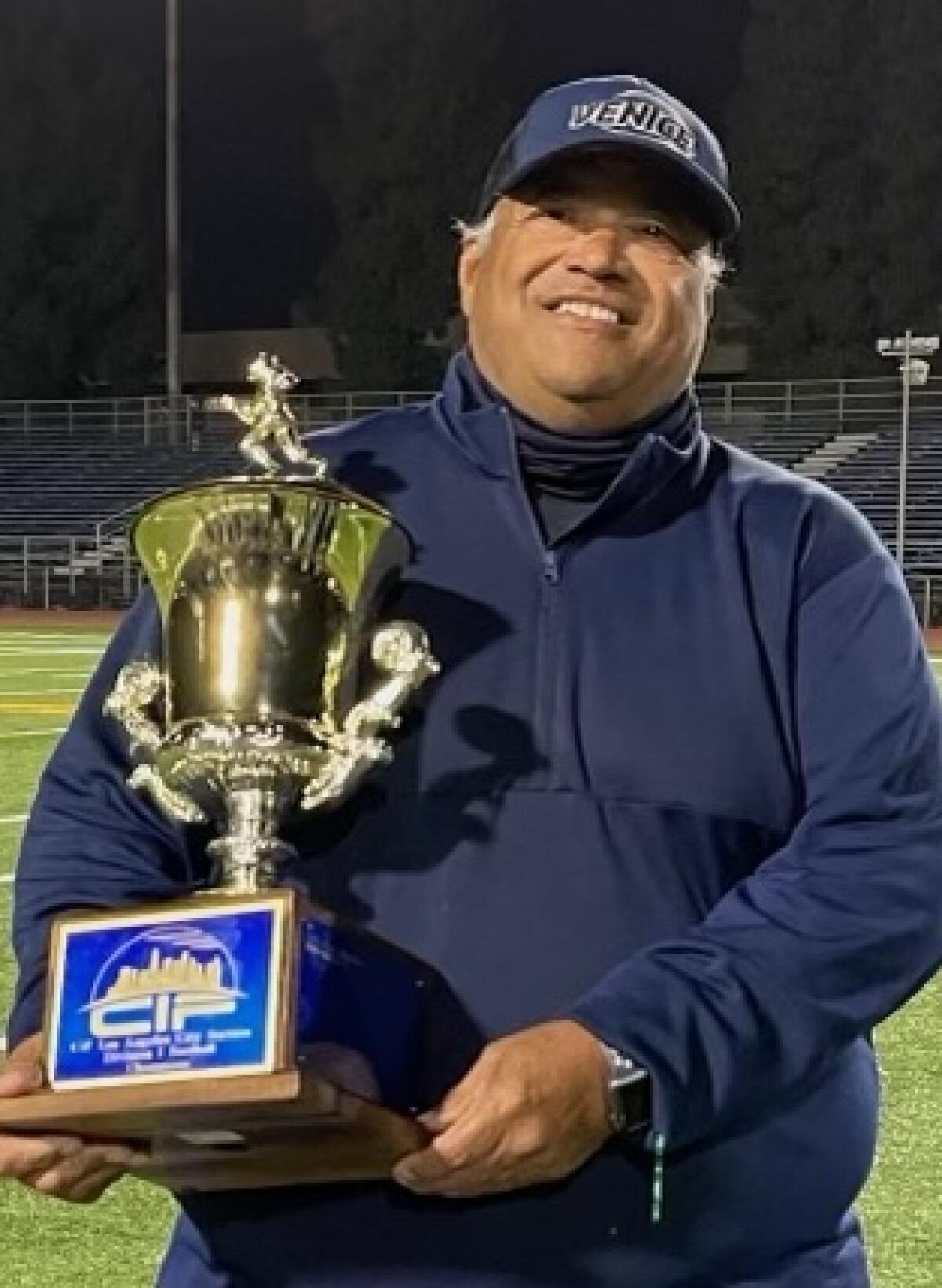 Venice coach Angelo Gasca showing off City Division I title trophy in 2021.