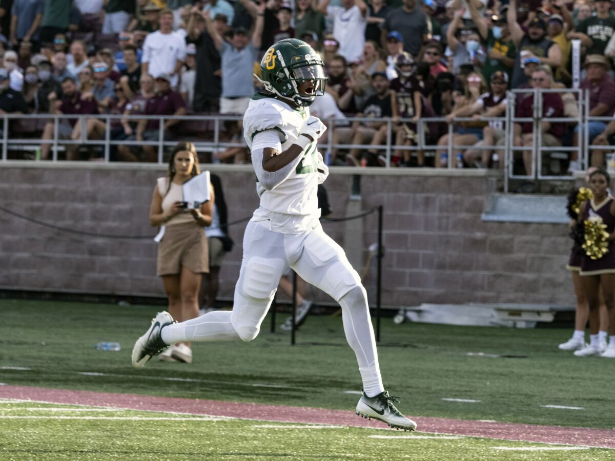 Baylor safety JT Woods scores after intercepting a pass against Texas State. 