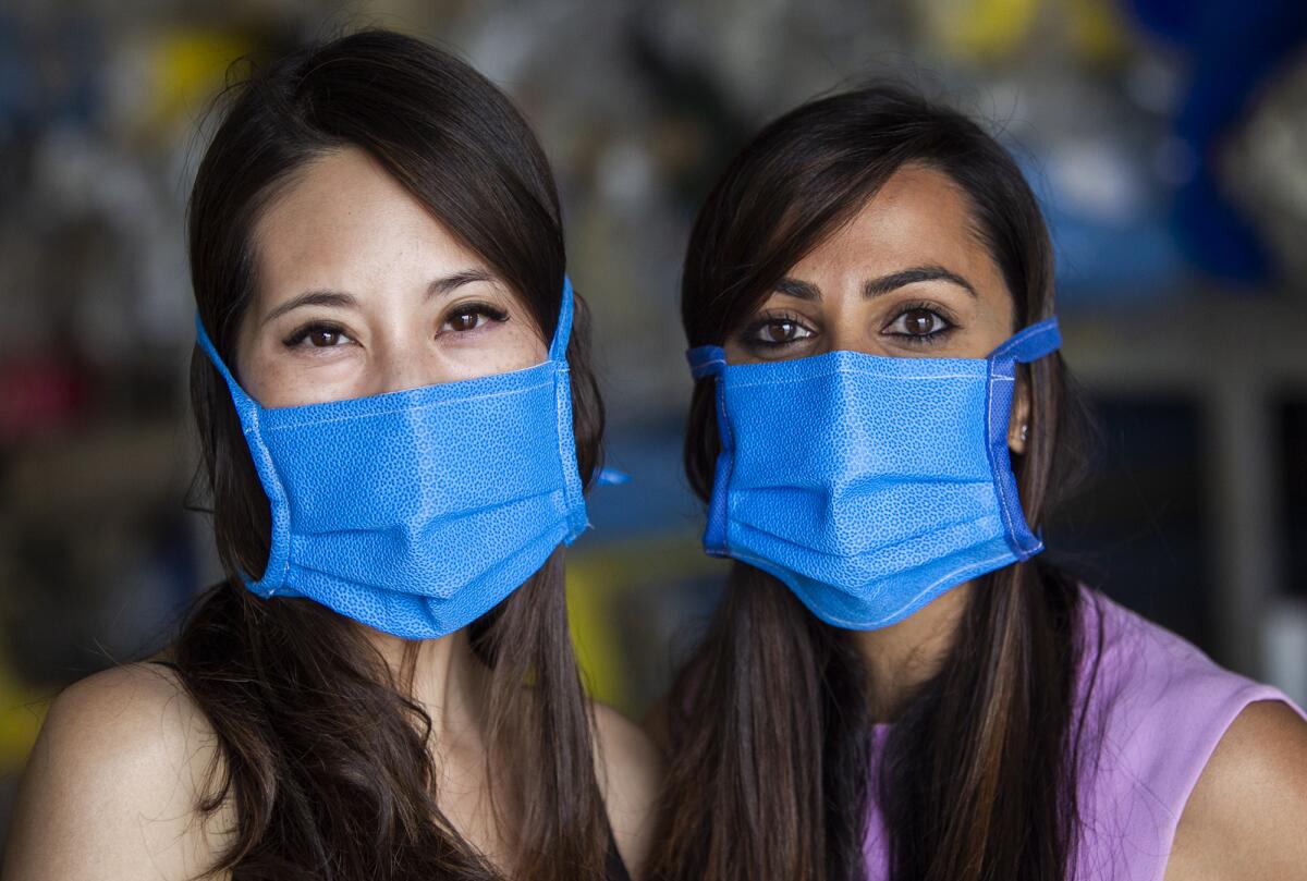 Dr. Melissa Chang, left, and Dr. Aditi Sharma, right, have teamed up to produce masks from recycled sterilization wraps.