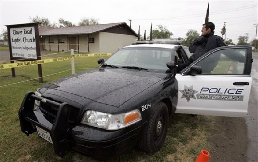 Police tape surrounds Clover Road Baptist Church in Tracy, Calif., Tuesday, April 7, 2009, near the home of Sandra Cantu. The body of Cantu, 8, was discovered inside a suitcase in an irrigation pond on Monday, April 6, 2009 after she was last seen at home on March 27, 2009. (AP Photo/Paul Sakuma)