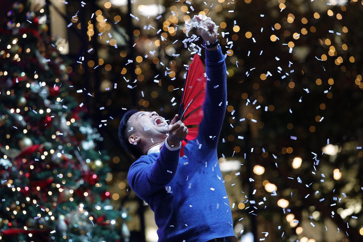 Magician Joseph Tran performs in a holiday show during the tree-lighting ceremony at the Americana at Brand in Glendale on Thursday.