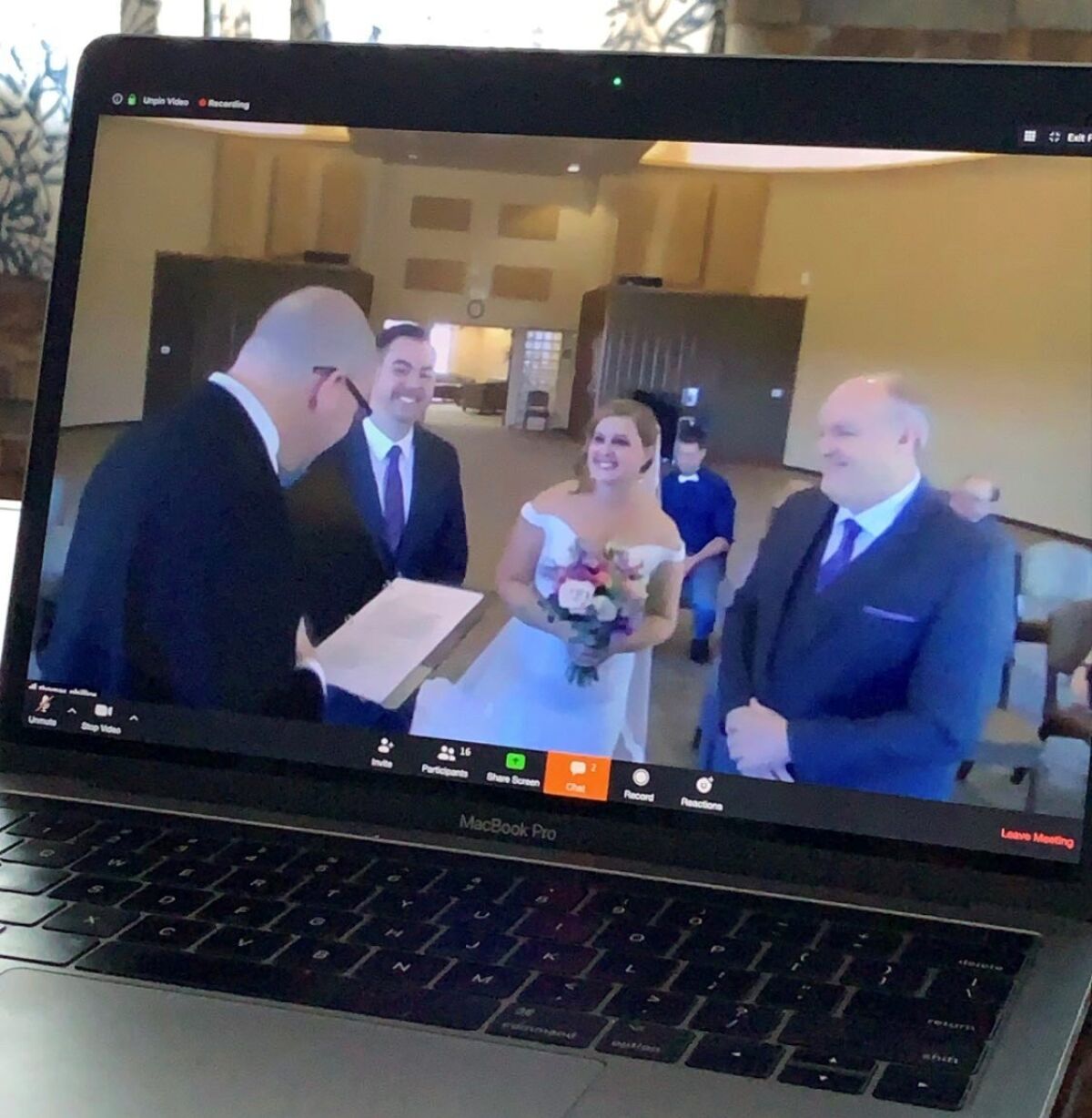 Heathe Fletcher, second from left, and Andrea Phillips put their wedding online so relatives could watch via Zoom.