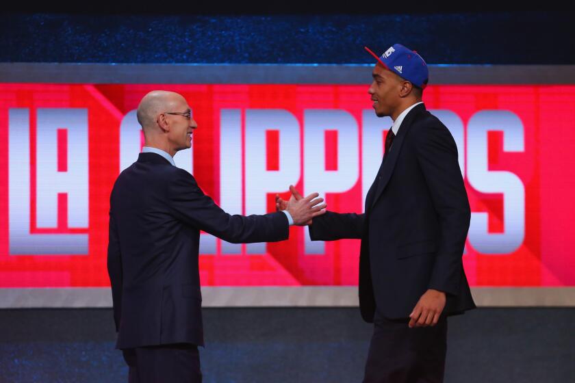 Clippers new draft pick Brice Johnson shakes hands with NBA Commissioner Adam Silver after being selected 25th overall.