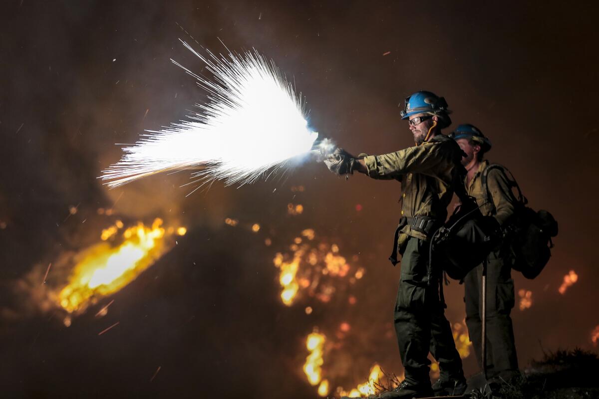 Firefighters battle the Bobcat fire on Angeles Crest Highway near Mt. Wilson on Sept. 22, 2020.