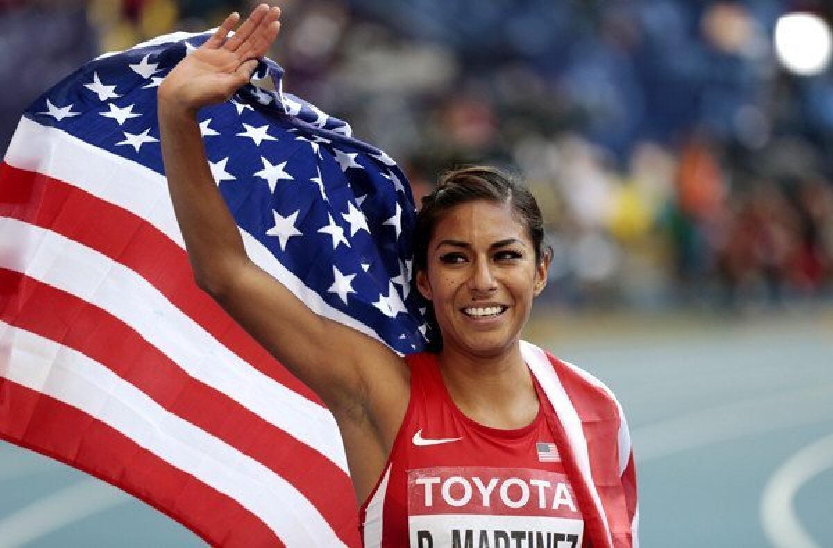 Brenda Martinez celebrates after earning a bronze medal in the women's 800-meter final at the world track championships Sunday in Moscow.