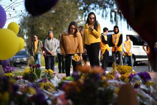 NEWBURY PARK-CA-JANUARY 27, 2020: Michelle Cordova, left, and Azul Cossio, right, pay their respects at a makeshift memorial outside of Kobe Bryantâs Mamba Sports Academy in Newbury Park on Monday, January 27, 2020. (Christina House / Los Angeles Times)