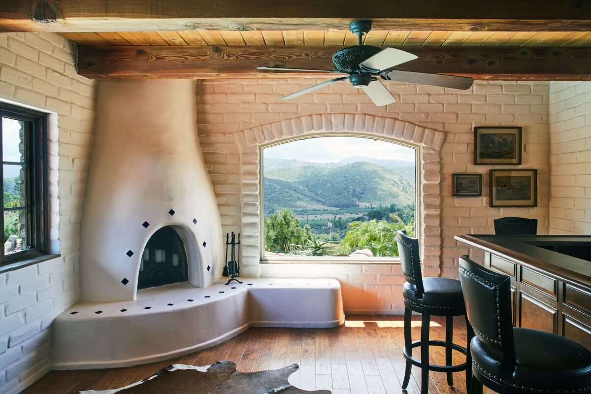 HOTCHKISS ADOBE: A traditional kiva fireplace creates a focal point by a window overlooking the San Pasqual Valley.