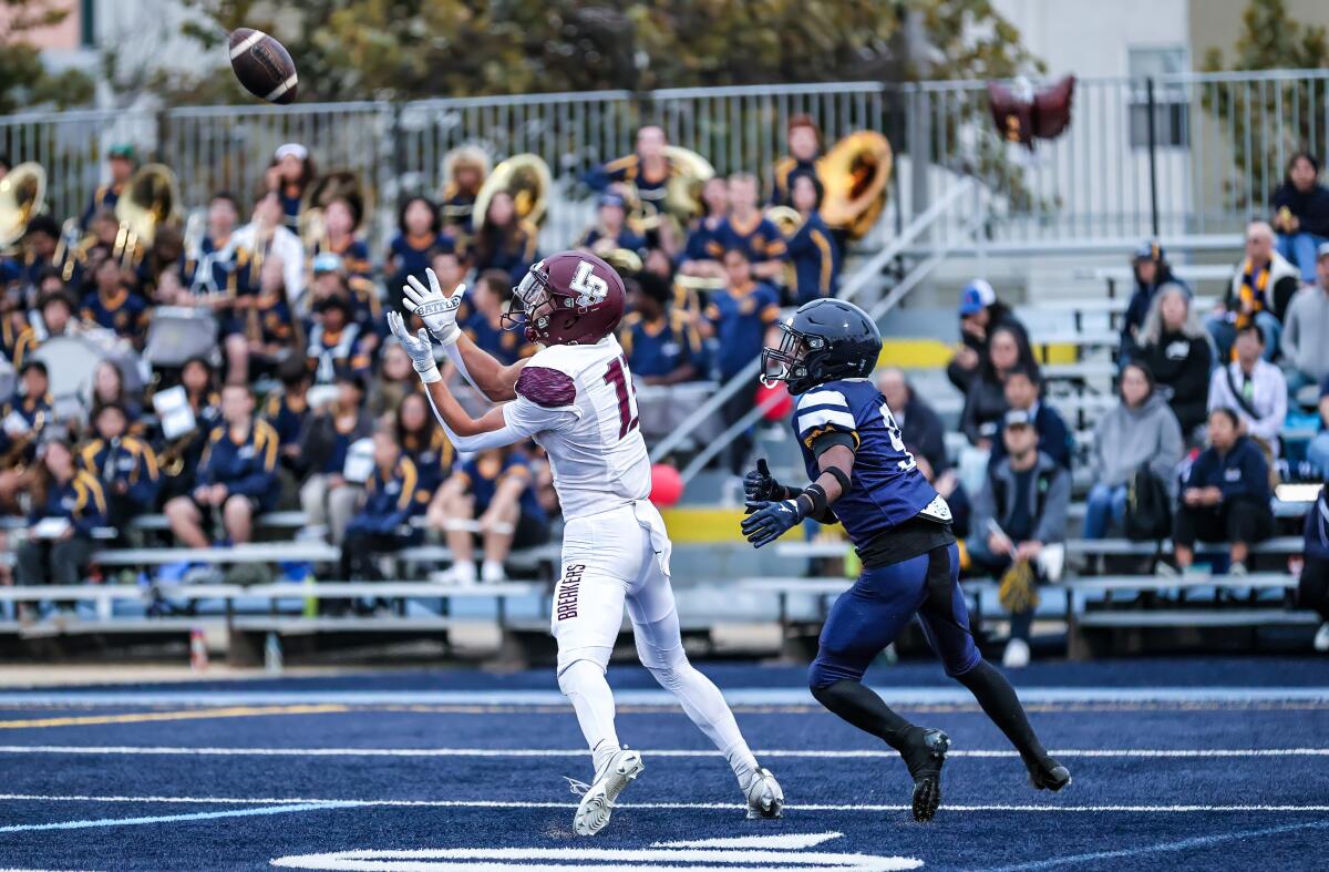 Luke Jolley of Laguna Beach catches a 50-yard touchdown pass on the first play of the game.