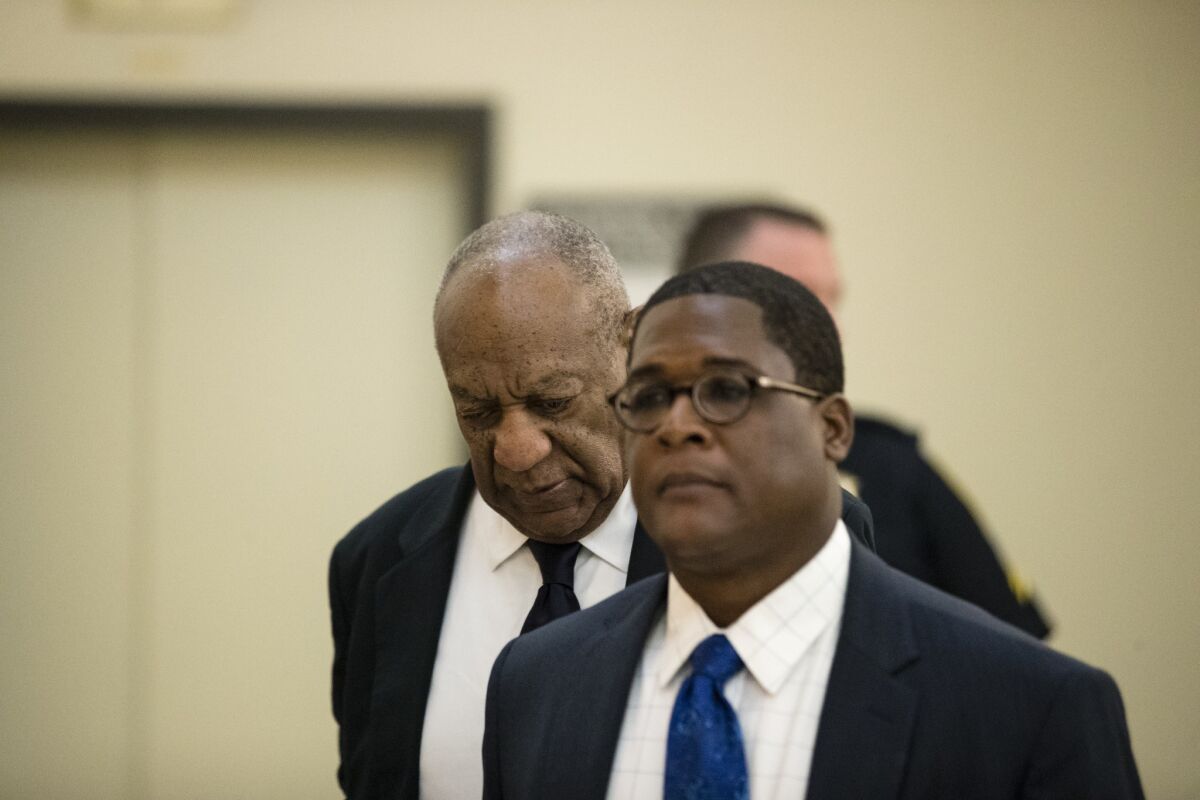 Bill Cosby, with spokesman Andrew Wyatt, enters court in Norristown, Pa.