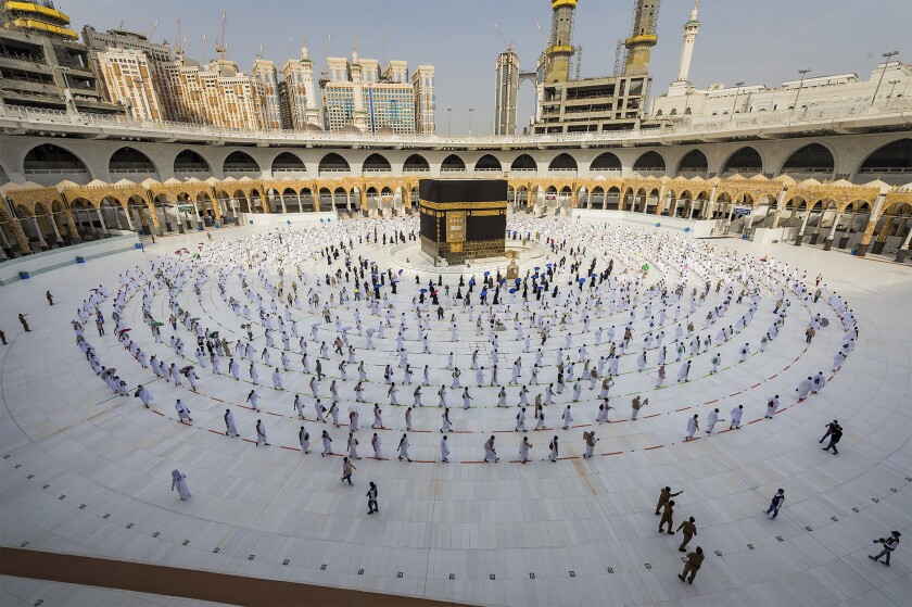 FILE - In this July 31, 2020, file photo, pilgrims walk around the Kabba at the Grand Mosque in the Muslim holy city of Mecca, Saudi Arabia. Saudi Arabia said Saturday, July 12, 2021, that this year's hajj pilgrimage will be limited to no more than 60,000 people, all of them from within the kingdom, due to the ongoing coronavirus pandemic. (Saudi Ministry of Media via AP, File)