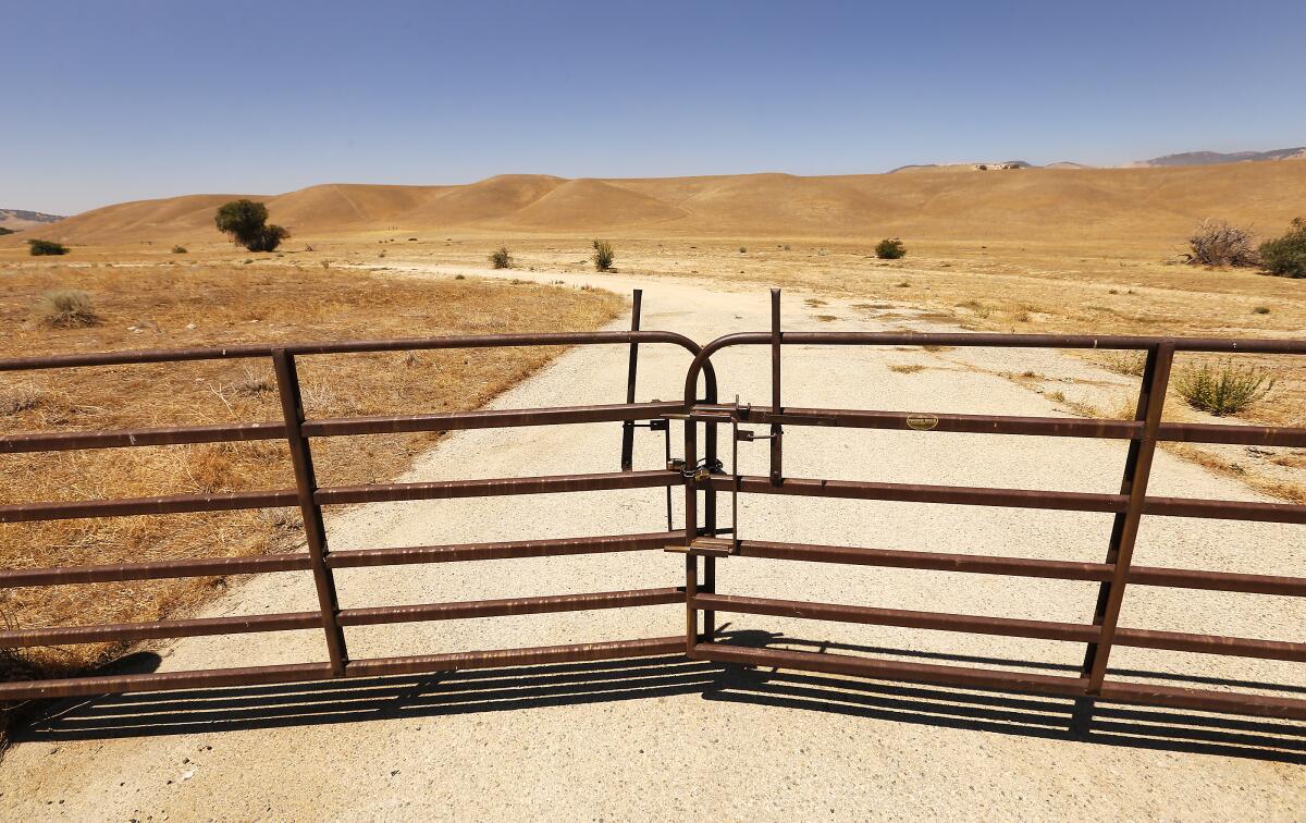 A gated dirt road in the sprawling grasslands of Tejon Ranch