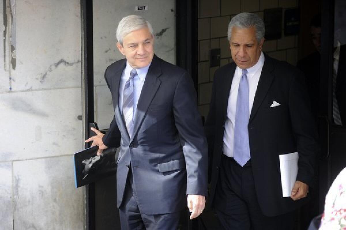 Former Penn State president Graham Spanier exits after the first day of his preliminary hearing in Harrisburg, Pa., Monday, July 29, 2013.