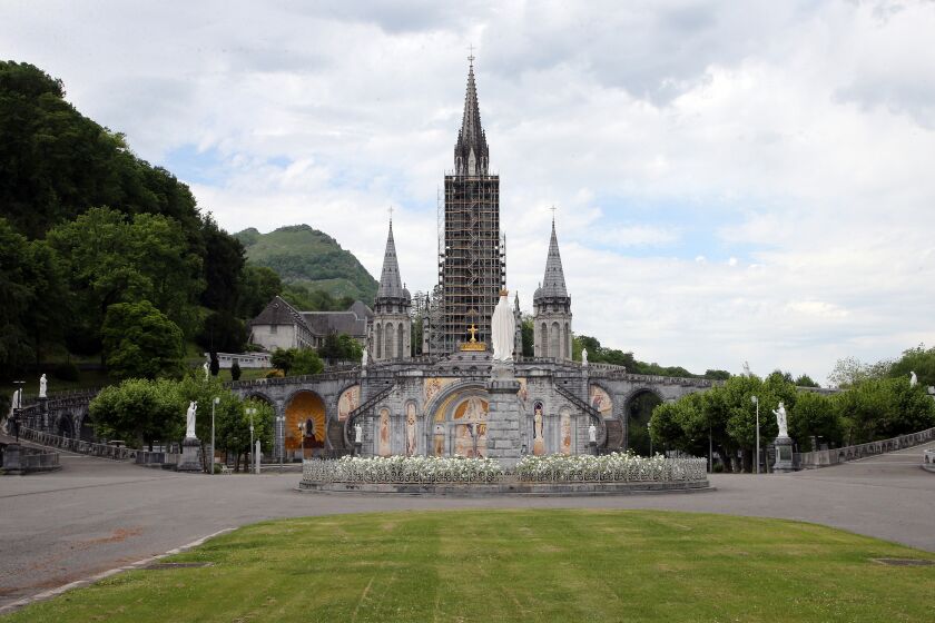 FILE - The closed Basilica of Lourdes is pictured May 8, 2020, in Lourdes, southwestern France. The Vatican came under pressure Tuesday, Dec. 6, 2022, to explain why it didn’t prosecute a famous Jesuit artist and merely let his order restrict the priest's ministry following allegations that he abused his authority over adult women. Mosiacs by Rev. Marko Ivan Rupnik decorate several churches and chapels, including the Lourdes basilica. (AP Photo/Bob Edme, File)