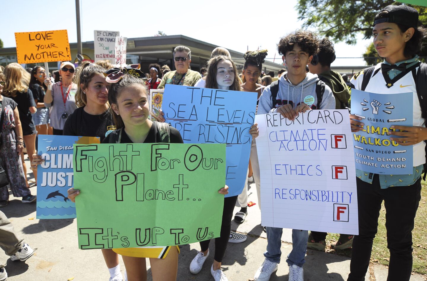 After walking out of classes, high school students participating in the Global Climate Strike gather in front of Mission Bay High School before marching to the Kendall-Frost Marsh Preserve for a rally there to demand action on the climate crisis in Pacific on Friday, September 20, 2019 in San Diego, California.