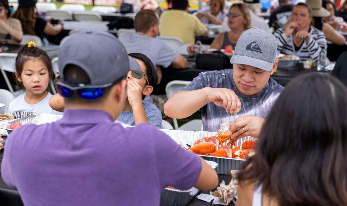 Crowds enjoy fresh Maine lobster at the Original Lobster Festival held at Fountain Valley Sports Park.