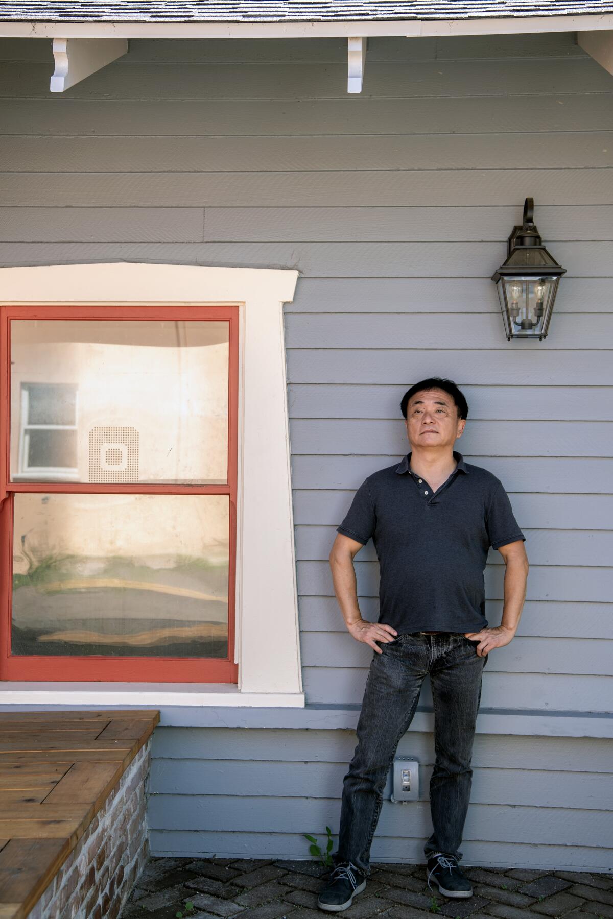 Architect Jingbo Lou in front of one of the converted Craftsman bungalows at Alpine Courtyard. 