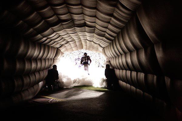 Vikings player Ray Edwards runs through the tunnel during pregame celebrations before Minnesota's Monday night game against the Green Bay Packers. The Vikings staved off a late comeback from Green Bay to win, 30-23.