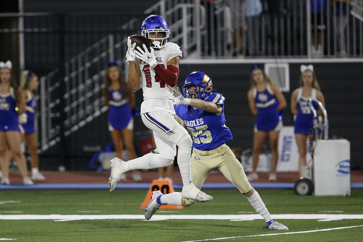 Los Alamitos' Makai Lemon catches a touchdown pass while being defended by Santa Margaritas' Christian Laliberte.