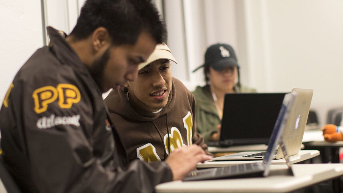 USC student Xavier Garcia, right, chats with friend Walter Solorzano, left, during a late-night study group session.