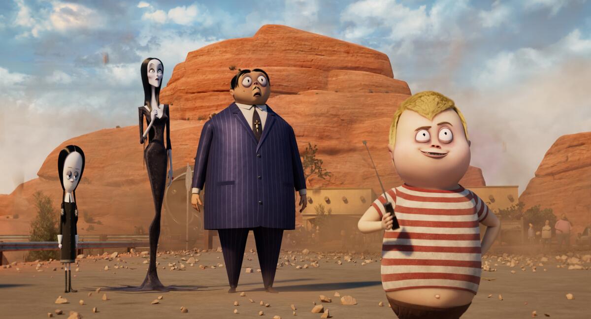 Wednesday, Morticia, Gomez and Pugsley Addams stand in the desert