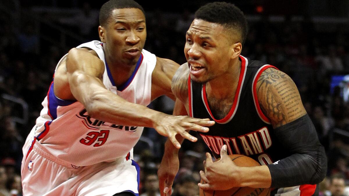 Trail Blazers guard Damian Lillard tries to drive past Clippers forward Wes Johnson during a game March 24, when Lillard scored 18 points but missed 12 of his 16 shots from the field.