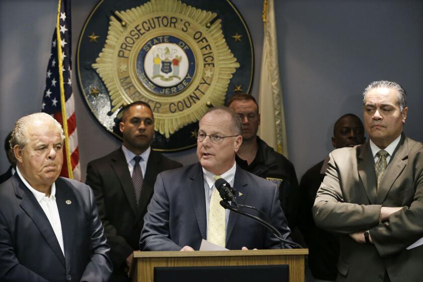 Mercer County Prosecutor Joseph L. Bocchini Jr., left, and Trenton Police Director Ralph Rivera Jr., right, listen as New Jersey State Police Supt. Col. Rick Fuentes answers a question after announcing that Gerald Tyrone Murphy, 38, had been shot and killed after a standoff with police.