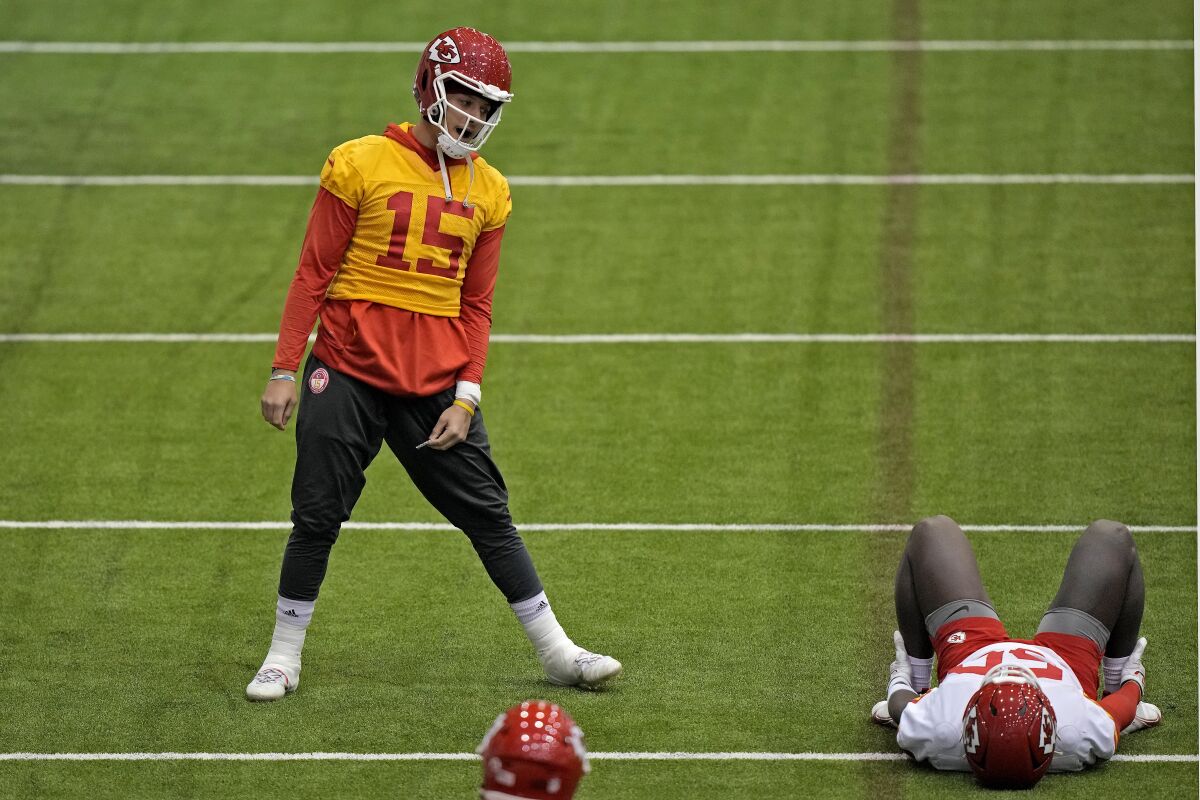 Kansas City Chiefs quarterback Patrick Mahomes (15) talks with linebacker Willie Gay (50) during a workout Thursday.