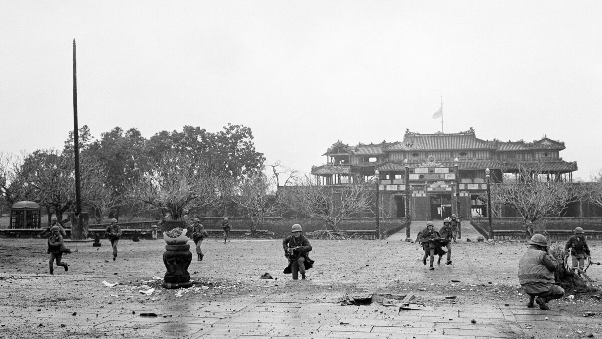 U.S. Marines and Vietnamese troops move through the grounds of the Imperial Palace in the old citadel area of Hue, Vietnam on Feb. 26, 1968.