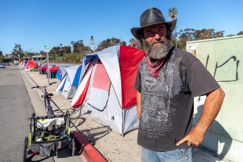 Rodney McGough, 52, who is homeless, is one of thirteen people who are living in tents alongside a stretch of S. Oceanside Blvd. in Oceanside. What once was an area full of trash left by homeless people is clean now because the people there are picking up litter and have a place to store their belongings. Rodney McGough is the one who brought order to the place. N photo by Don Boomer