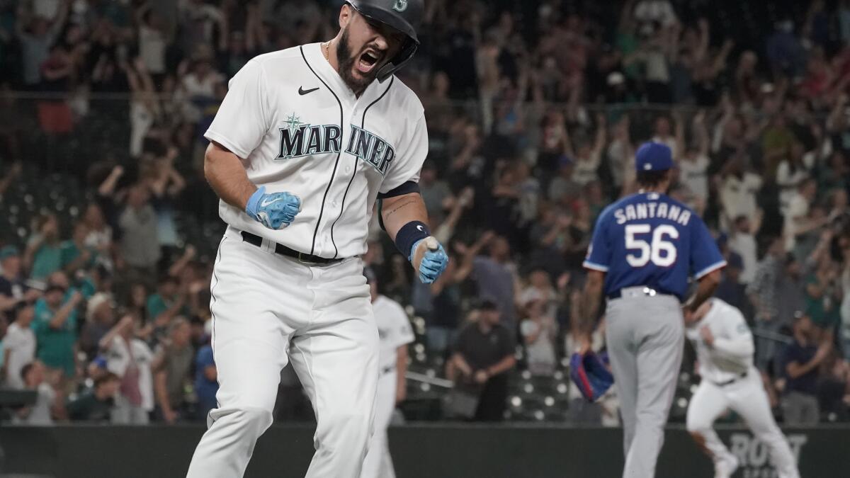 Seattle Mariners' Edgar Martinez watches his sacrifice fly to