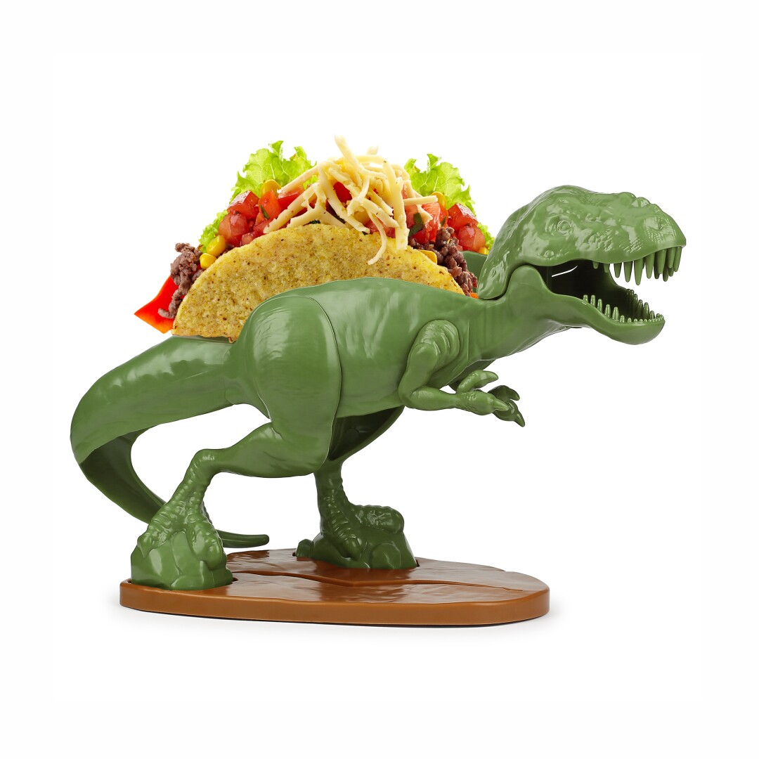A plastic Tyrannosaurus Rex holds a taco on its back.