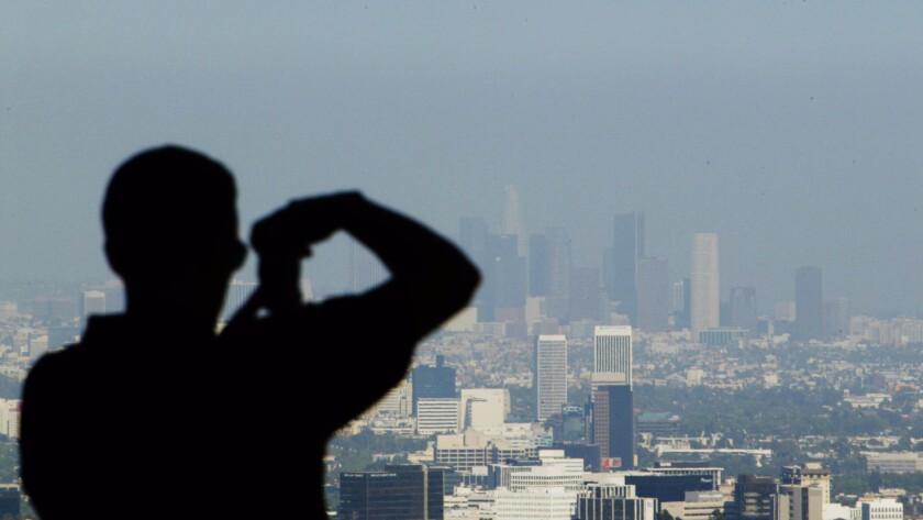 A nationwide study finds that Southern California has the most to gain from stricter air quality standards, which could prevent thousands of premature deaths each year. Above, a hazy view of downtown Los Angeles.