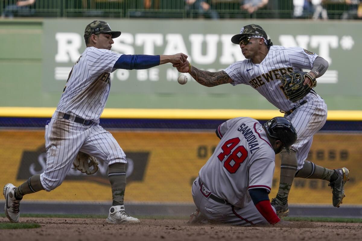 The Milwaukee Brewers score two runs on a pair of fielder's choice