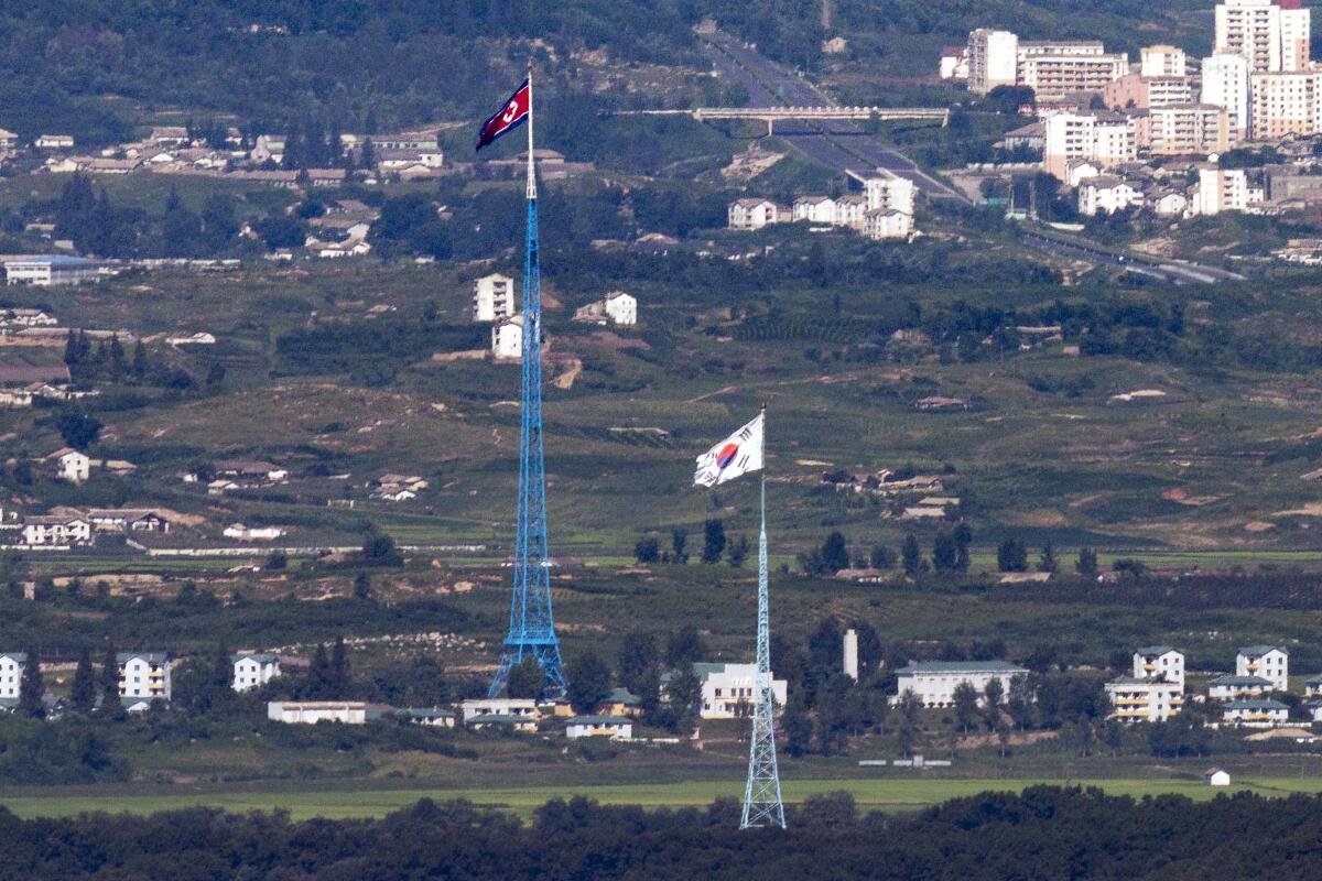 Flags of North Korea and South Korea fly in the border area between the two Koreas.