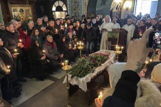 Relatives and friends pay their last respects at the coffin of Russian opposition leader Alexei Navalny in the Church of the Icon of the Mother of God Soothe My Sorrows, in Moscow, Russia, Friday, March 1, 2024. (AP Photo)