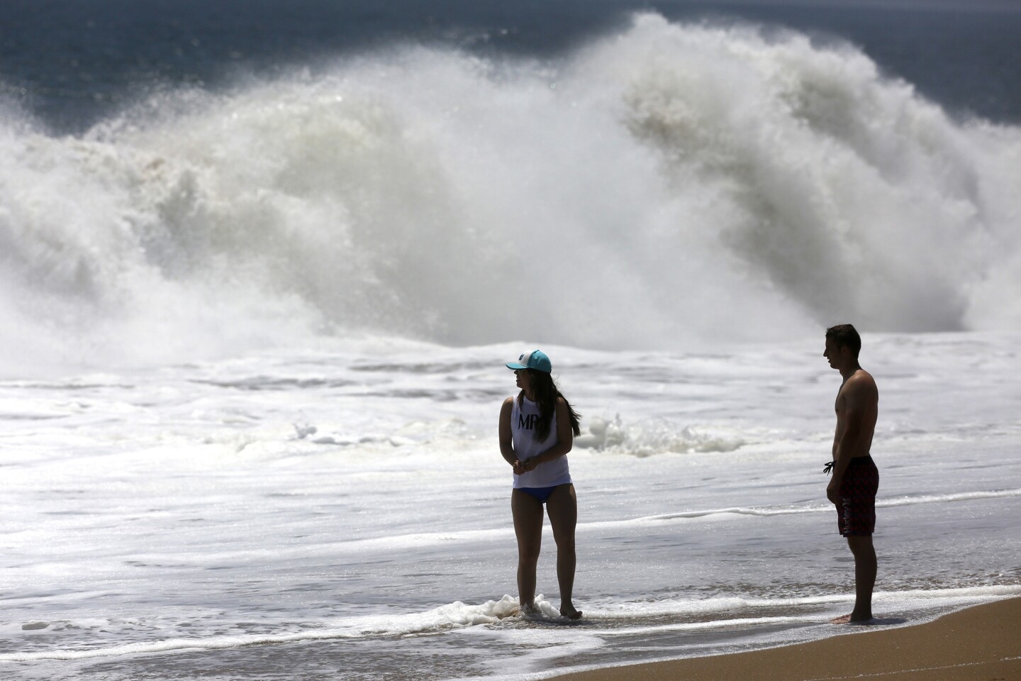 People watch the waves at the Wedge in Newport Beach.