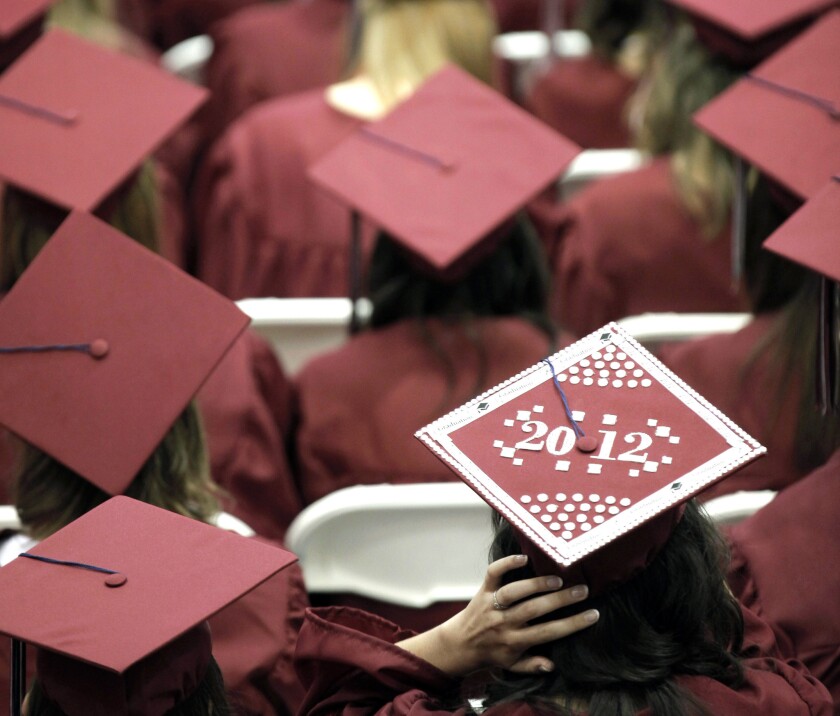 Graduates from Joplin High School listen to speakers during commencement ceremonies in Joplin, Mo. U.S. public high schools have reached a milestone, an 80% graduation rate.