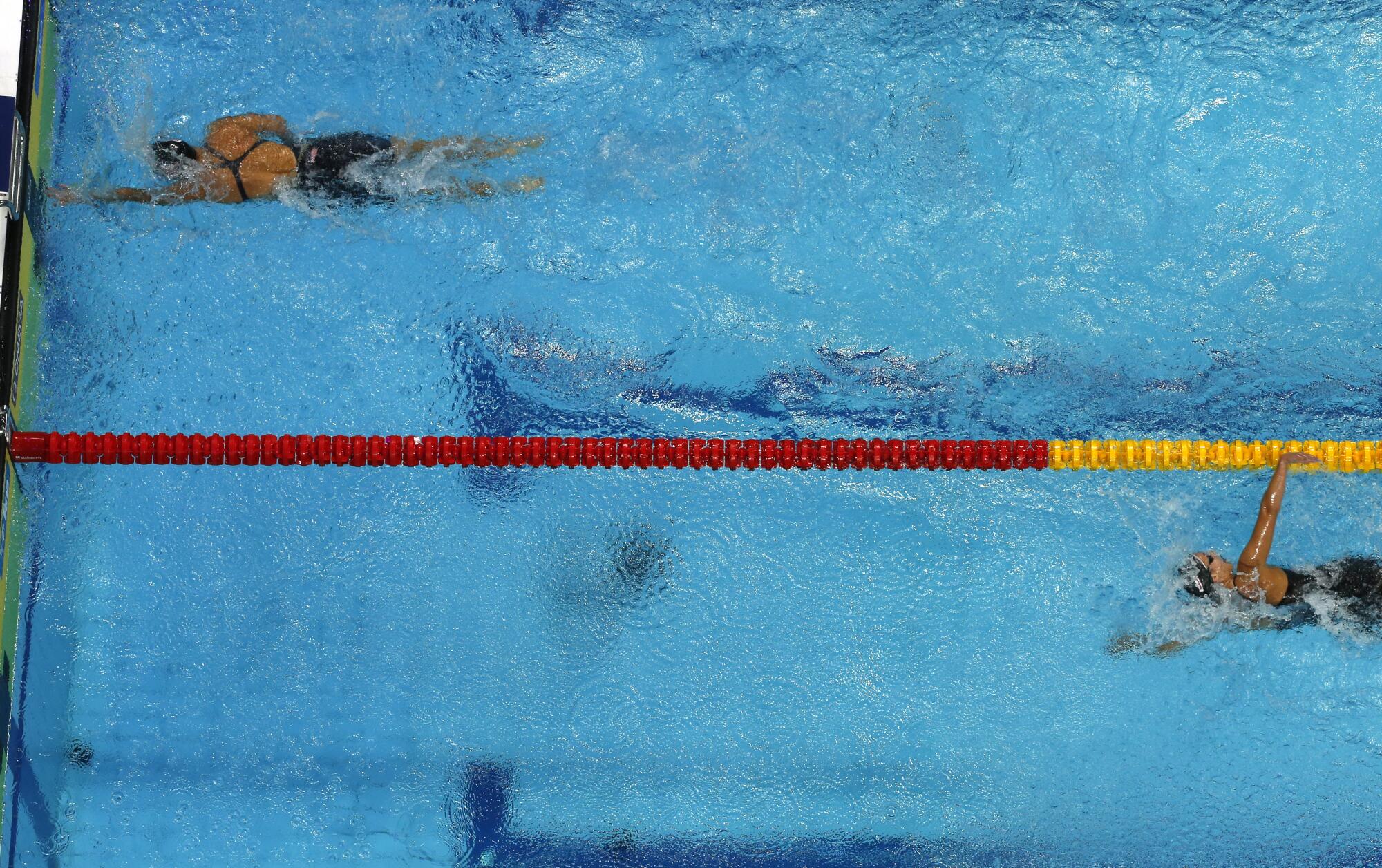 Katie Ledecky, left, finishes the women's 400-meter freestyle final far ahead of her competitors