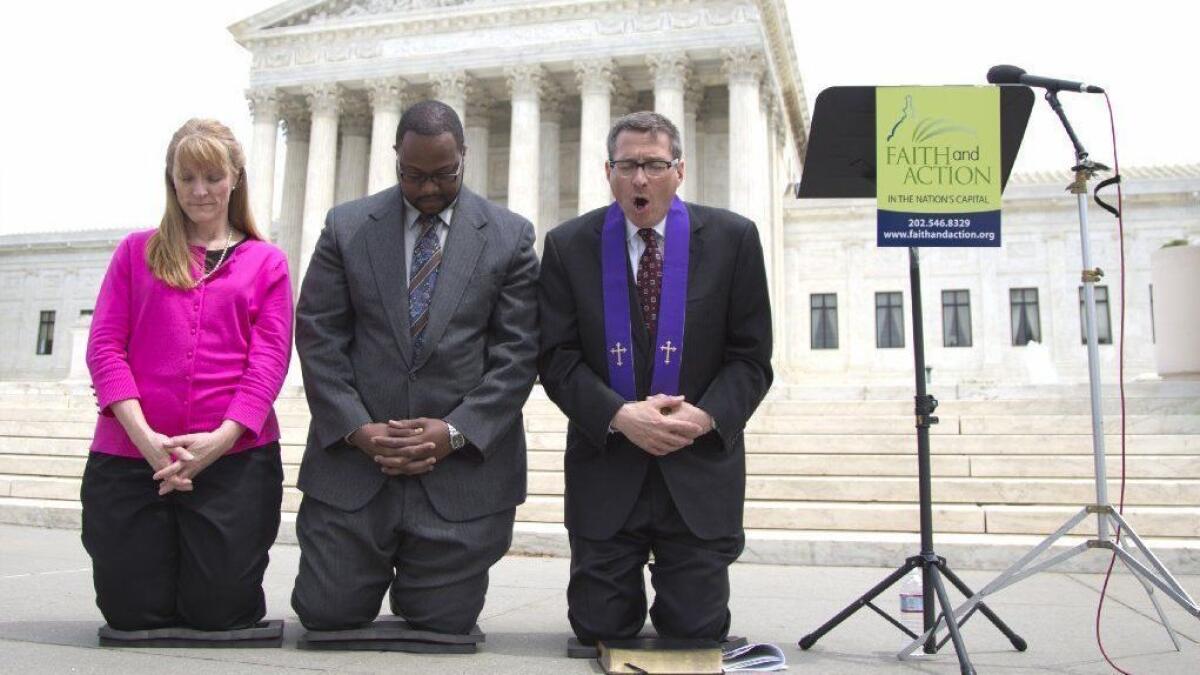 Christian activists pray in front of the Supreme Court after the justices ruled in favor of the Town of Greece, N.Y., in a public prayer case on May 5, 2014.