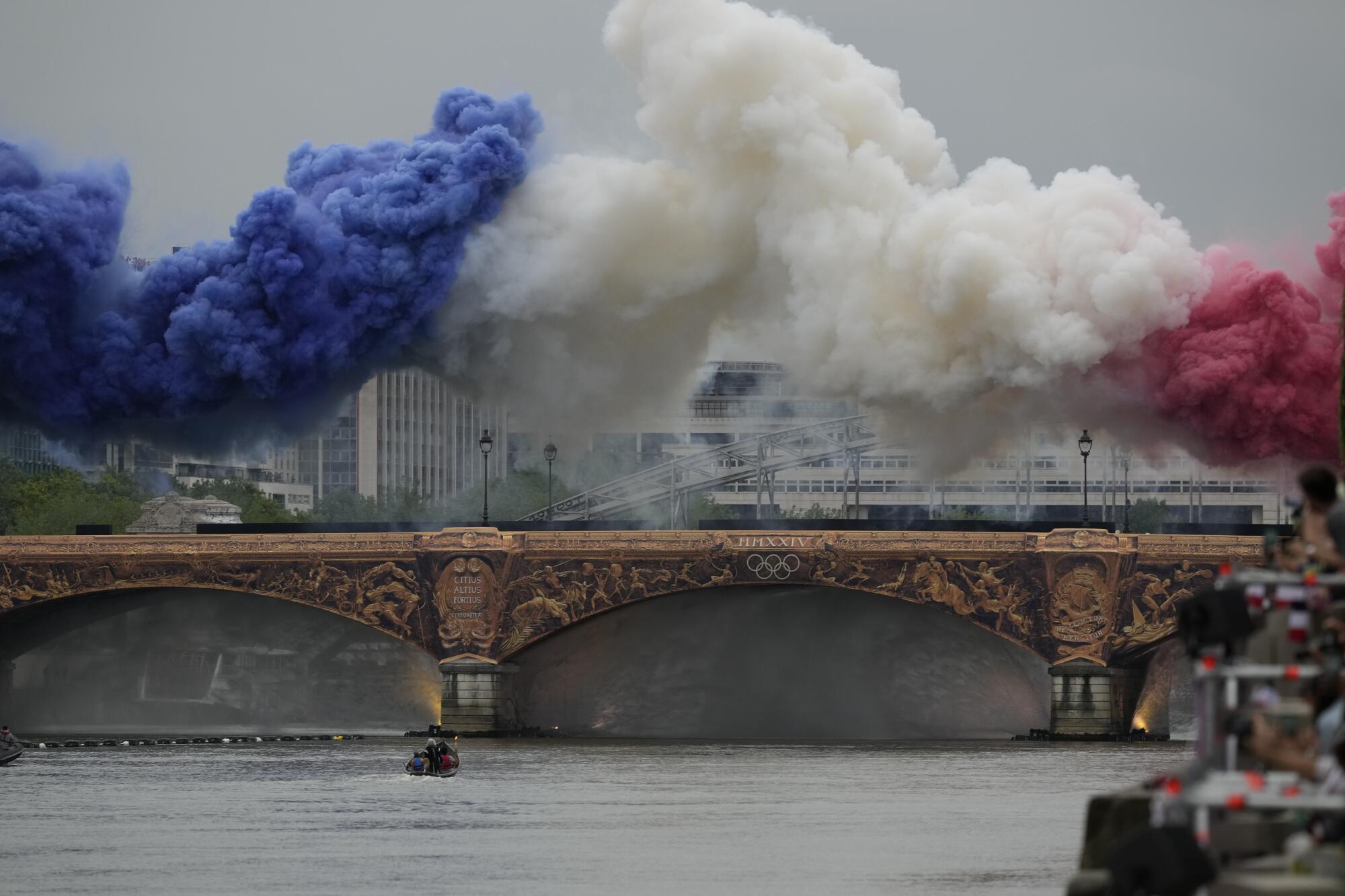 Smoke in the colours of the French flag billows in Paris during the opening ceremony.