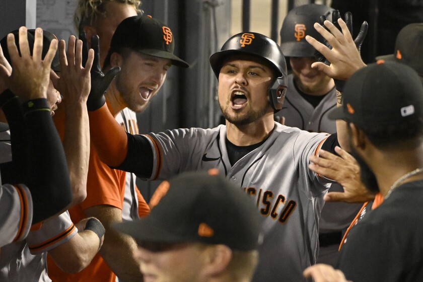 San Francisco's J.D. Davis celebrates in the dugout after hitting a home run in the third inning.