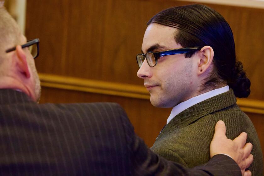 SANTA ANA CA JANUARY 18, 2024 - Marcus Anthony Eriz, right, with public defender Randall Bethune during the opening statements on Jan. 18, 2024, in Eriz's trial for the killing a 6-year-old Aiden Leos in a road-rage incident on the 55 Freeway in May 2021. Eriz is accused of fatally shooting Aiden Leos on May 21, 2021 as his mom drove him to kindergarten. (Irfan Khan / Los Angeles Times)