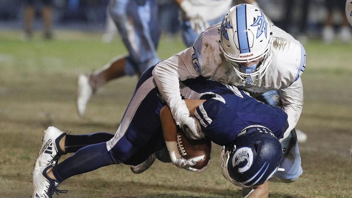 Corona del Mar High's Carter Duss tackles Camarillo's Tyler Macasieb for a loss in the semifinals of the CIF Southern Section Division 4 playoffs on Nov. 16.