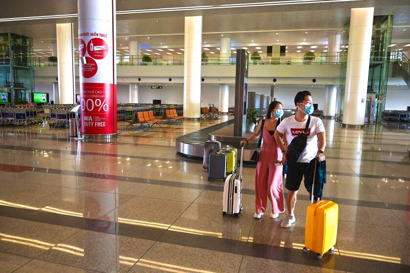 Passengers walk through the empty arrivals hall of Noi Bai International Airport in Hanoi on Feb. 27.