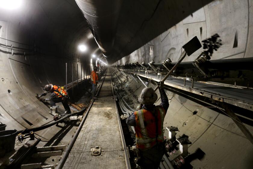 LOS ANGELES, CA-APRIL 5, 2017: The muck, a combination of earth and chemicals and water, is whisked along the conveyor belt l at speeds of up to 600 feet a minute. If it falls of the conveyor, miners must shovel it back at the tail end of the tunnel boring machine located deep underneath the streets of downtown Los Angeles. (Mel Melcon/Los Angeles Times)