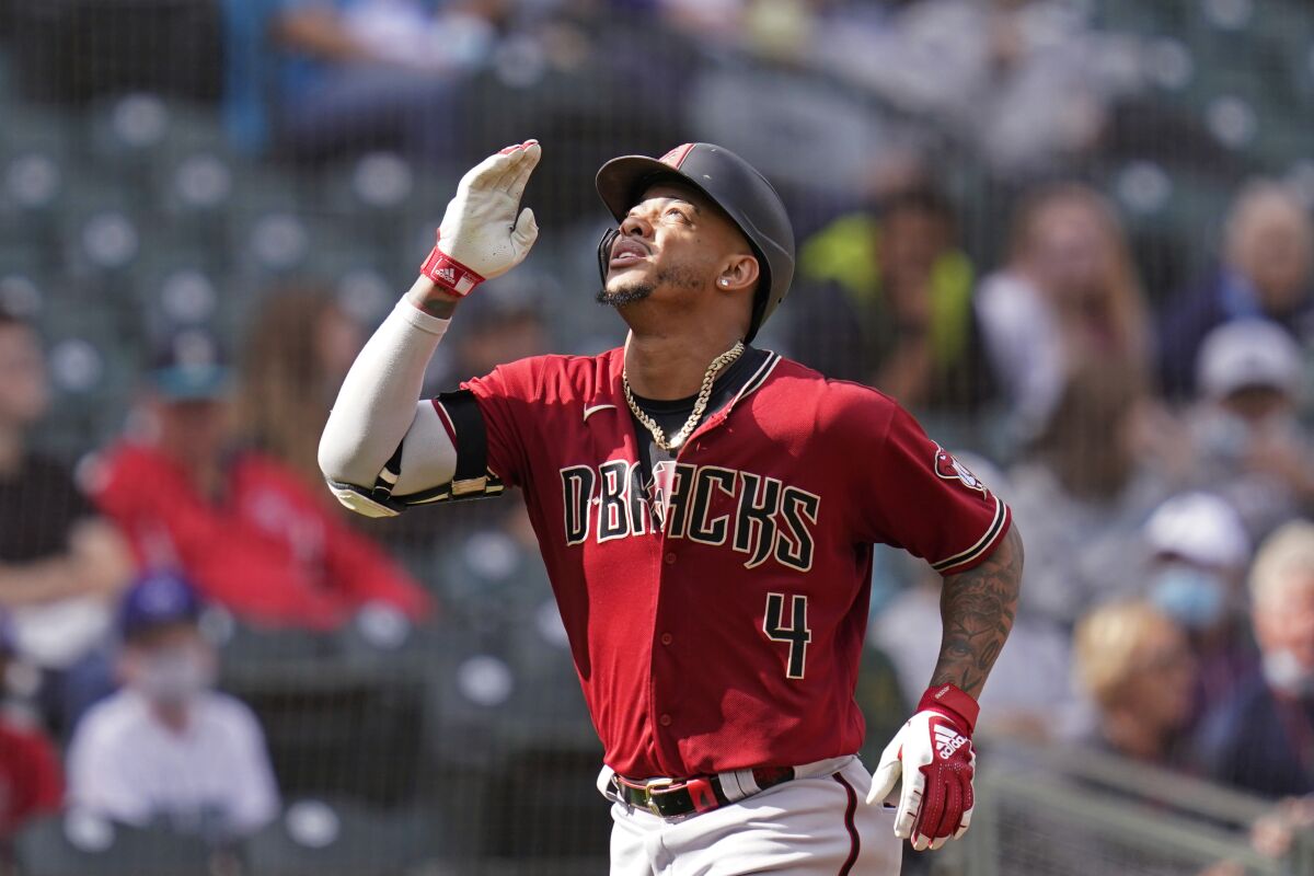 Arizona Diamondbacks' Ketel Marte motions as he heads home on his solo home run against the Seattle Mariners in the seventh inning of a baseball game Sunday, Sept. 12, 2021, in Seattle. (AP Photo/Elaine Thompson)