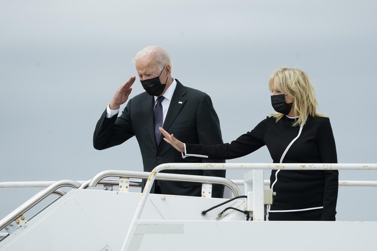 President Biden salutes and First Lady Jill Biden lifts her hand as they board on Air Force One.