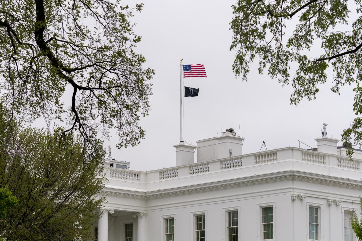 A POW/MIA flag, symbolizing America's Missing in Action and Prisoners of War, flies above the White House, Friday