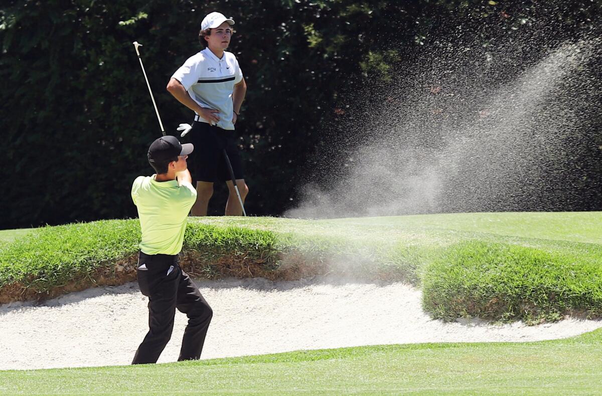 Edison's Troy Tarvin chips out of the bunker during the CIF State boys' golf championship at the San Gabriel Country Club.